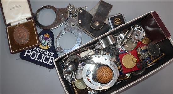 Assorted items including badges, handcuffs and golf memorabilia.